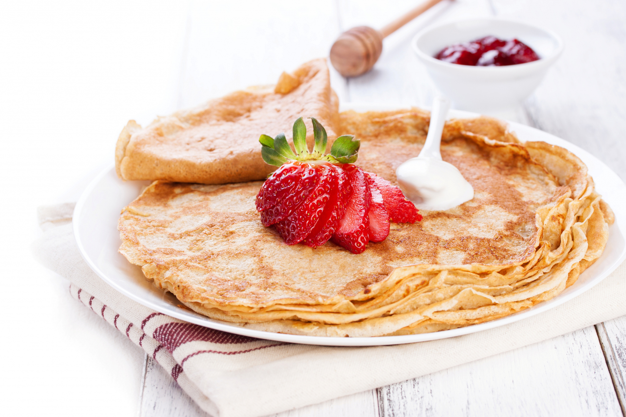 close-up-of-crepes-with-cream-and-strawberries.jpg